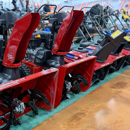Outdoor Power EquipmentRow of red snow blowers on display at a store